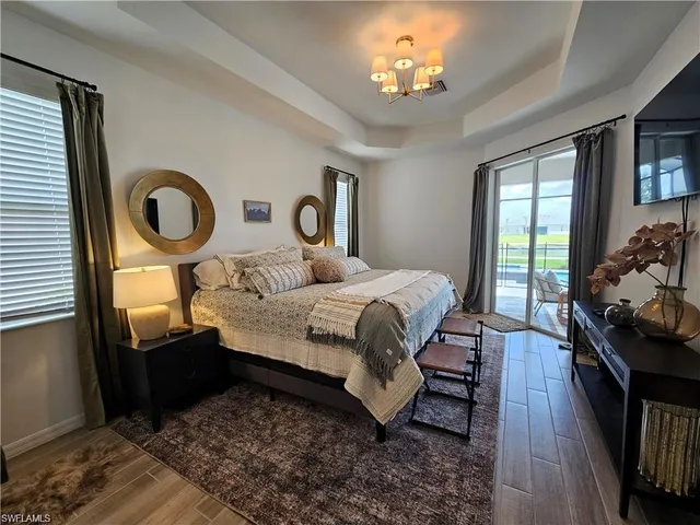 a bedroom with a bed mirror and window