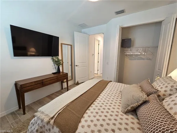a bedroom with a bed and a flat screen tv