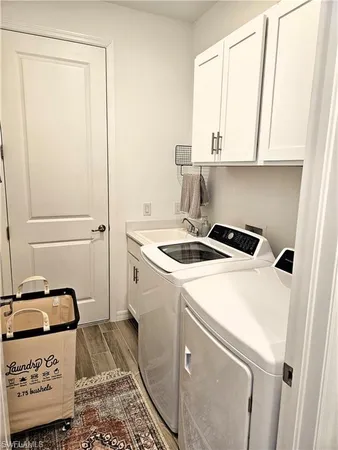 a utility room with a sink washer and dryer