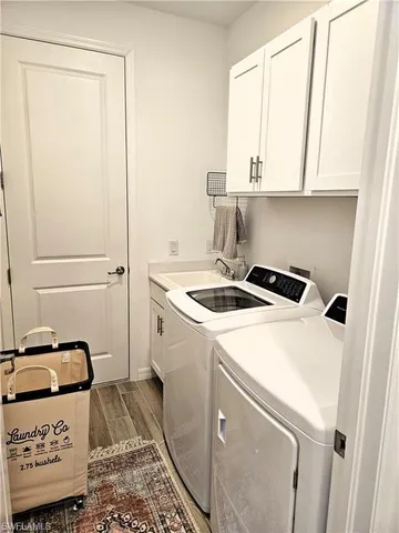 a utility room with a sink washer and dryer