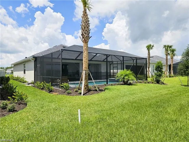a view of a house with backyard and porch