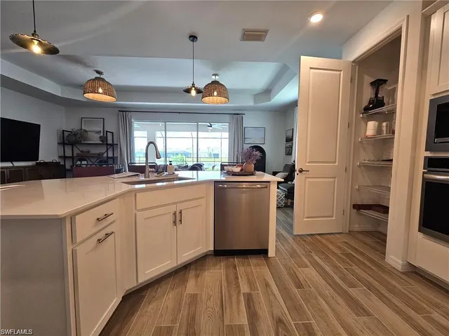 a kitchen with a sink appliances and cabinets