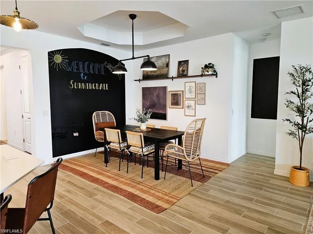 a view of a dining room with furniture and wooden floor