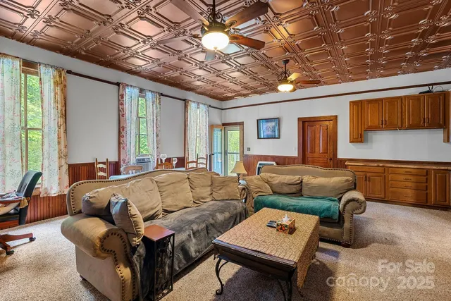 a living room with furniture a couch and a ceiling fan