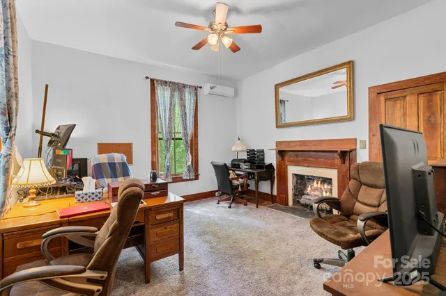 a room with furniture a fireplace and a flat screen tv