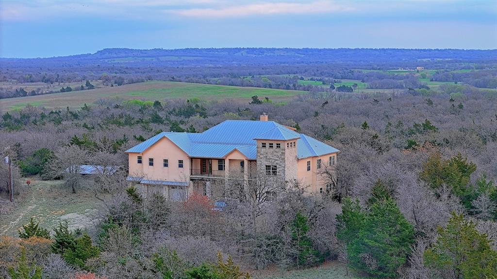 a view of a house with a yard and mountain view