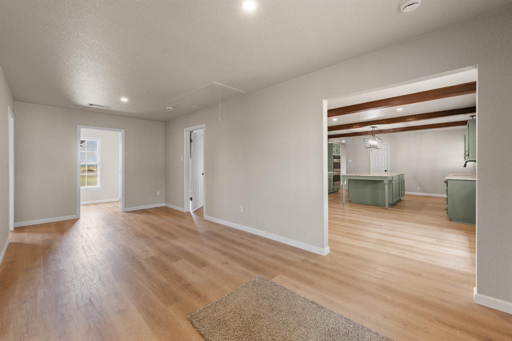 401 Edgewood Lane Cleburne, TX 76031 - Photo 17 of 39 a view of a room with wooden floor and windows