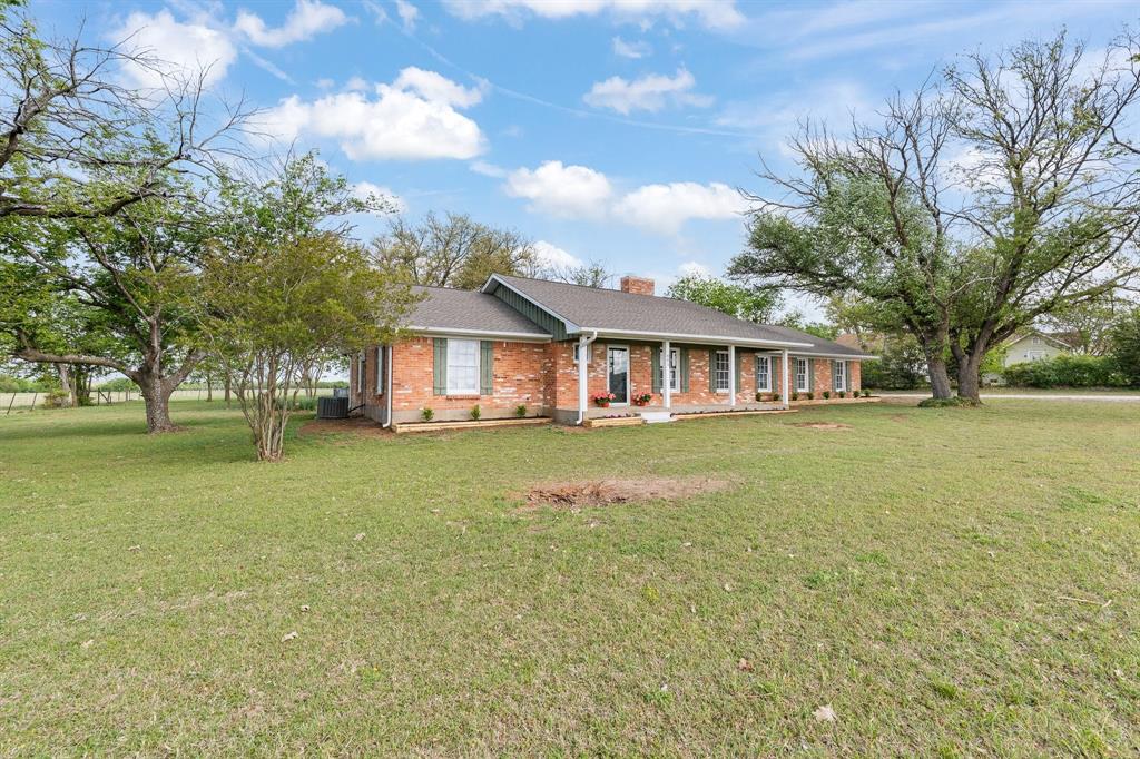 401 Edgewood Lane Cleburne, TX 76031 - Photo 2 of 39 a view of a house with a garden and yard
