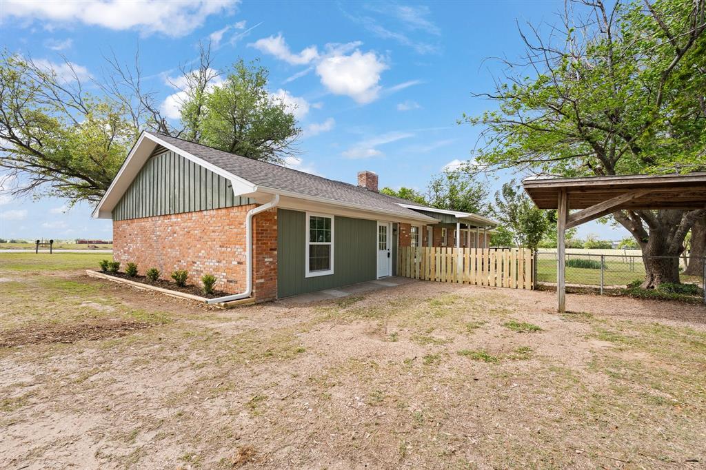 401 Edgewood Lane Cleburne, TX 76031 - Photo 24 of 39 a view of a house with a yard and potted plants