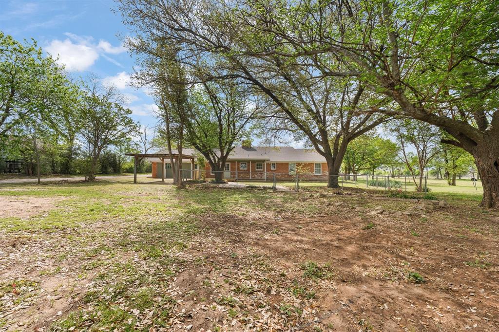 401 Edgewood Lane Cleburne, TX 76031 - Photo 27 of 39 a front view of house with yard and green space