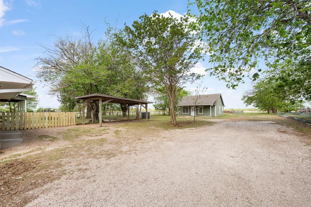 401 Edgewood Lane Cleburne, TX 76031 - Photo 37 of 39 a front view of a house with a garden and tree