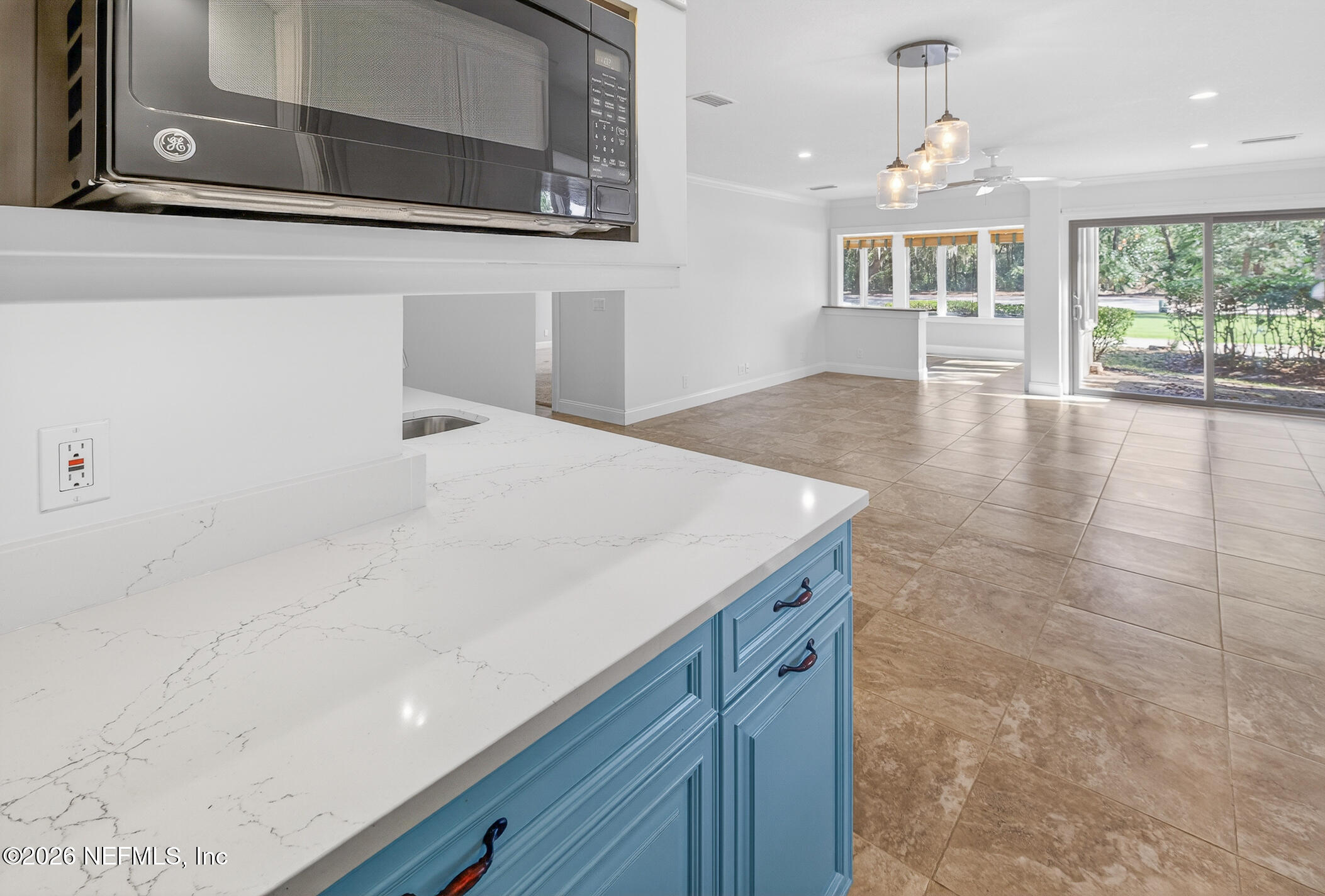 3301 Sea Marsh Road Fernandina Beach, FL 32034 - Photo 16 of 41 a view of a hallway with wooden floor and chandelier