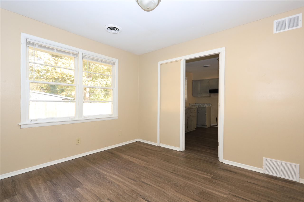 786 North Mendenhall Road Memphis, TN 38122 - Photo 11 of 14 a view of an empty room with wooden floor and a window