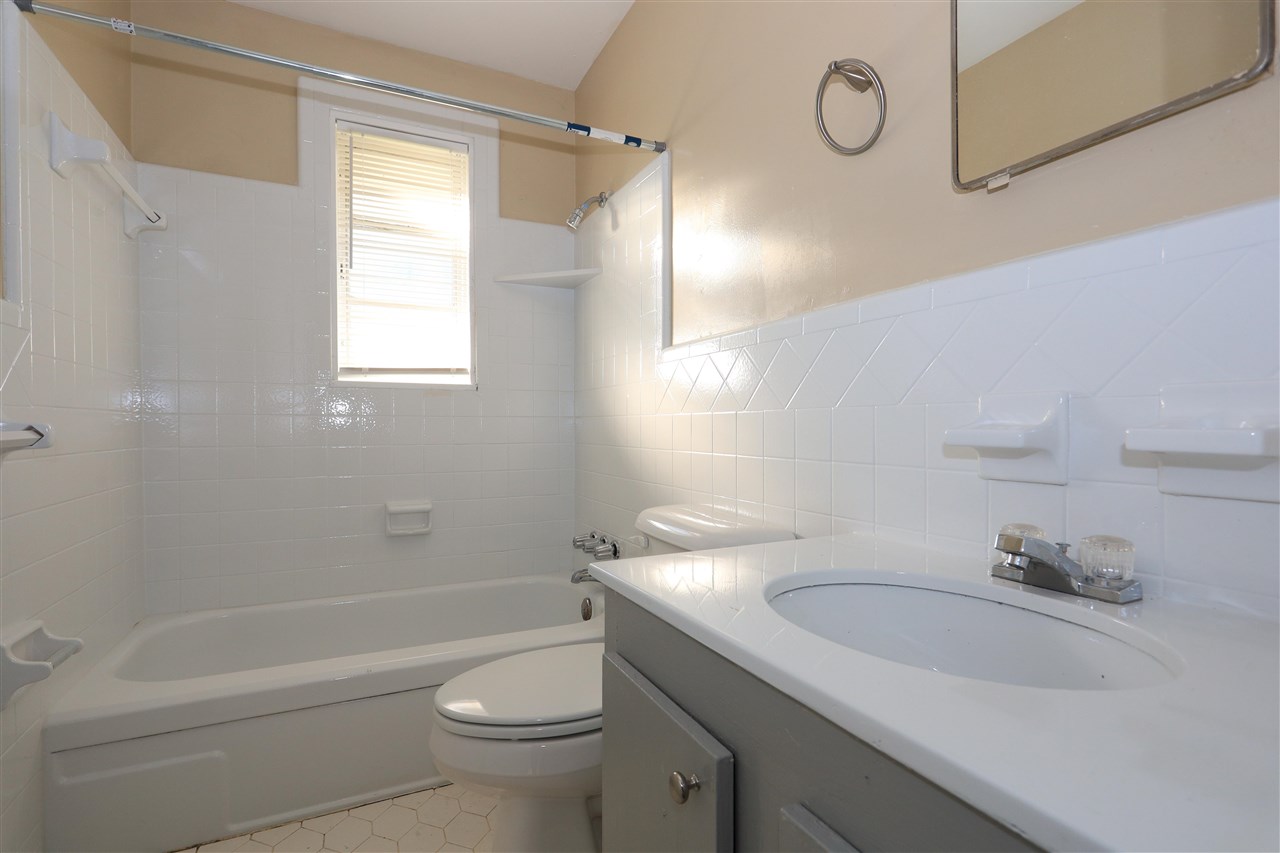 786 North Mendenhall Road Memphis, TN 38122 - Photo 14 of 14 a bathroom with a granite countertop sink a toilet and shower