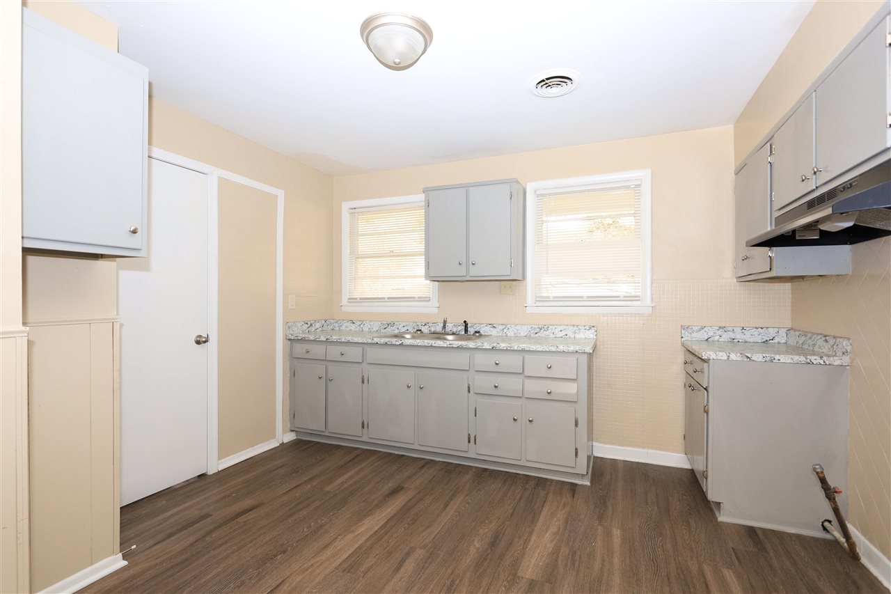 786 North Mendenhall Road Memphis, TN 38122 - Photo 7 of 14 a room with granite countertop cabinets a sink and a window