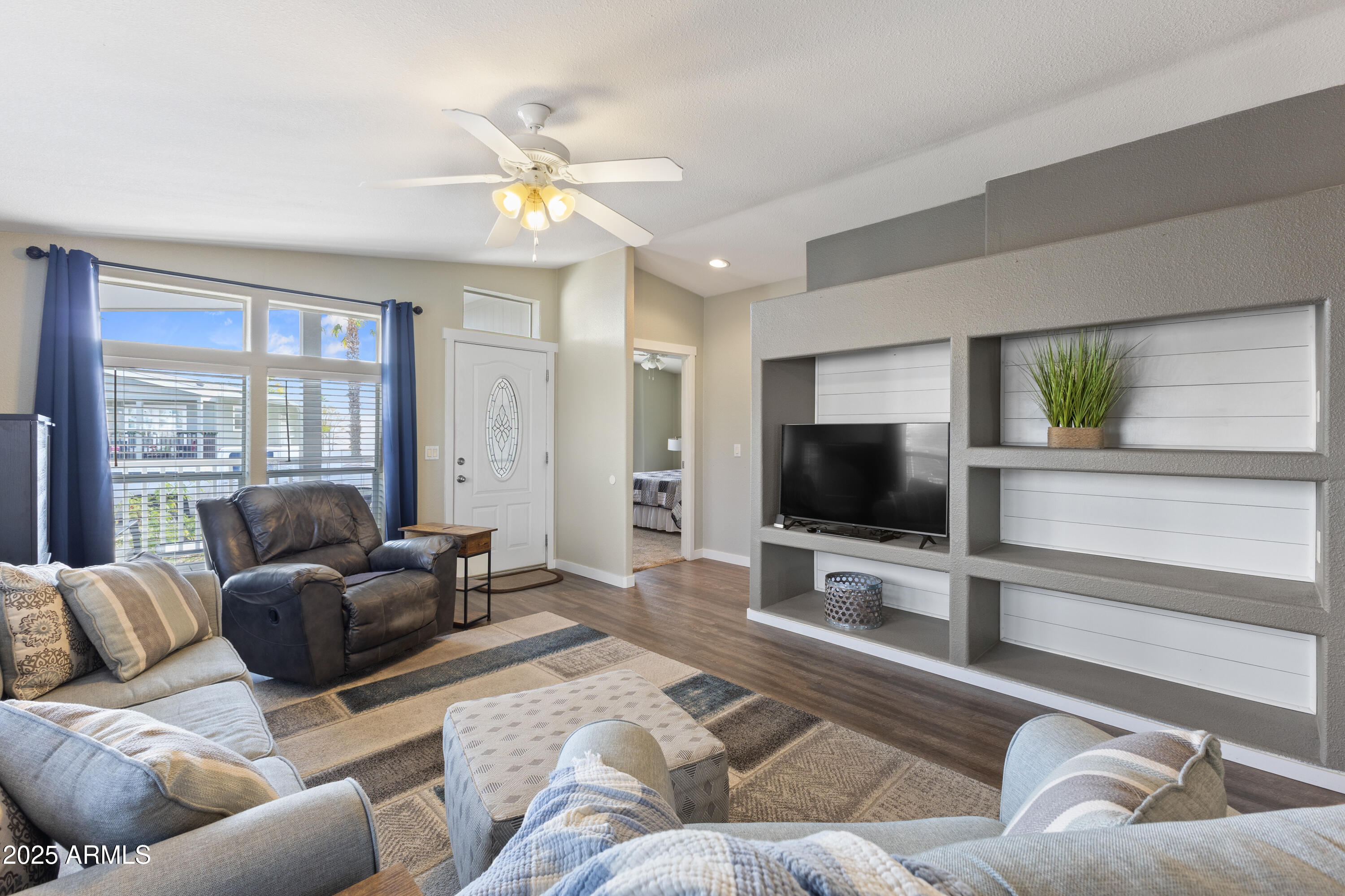 2000 South Apache Road, Unit 156 Buckeye, AZ 85326 - Photo 11 of 40 a living room with furniture and a flat screen tv