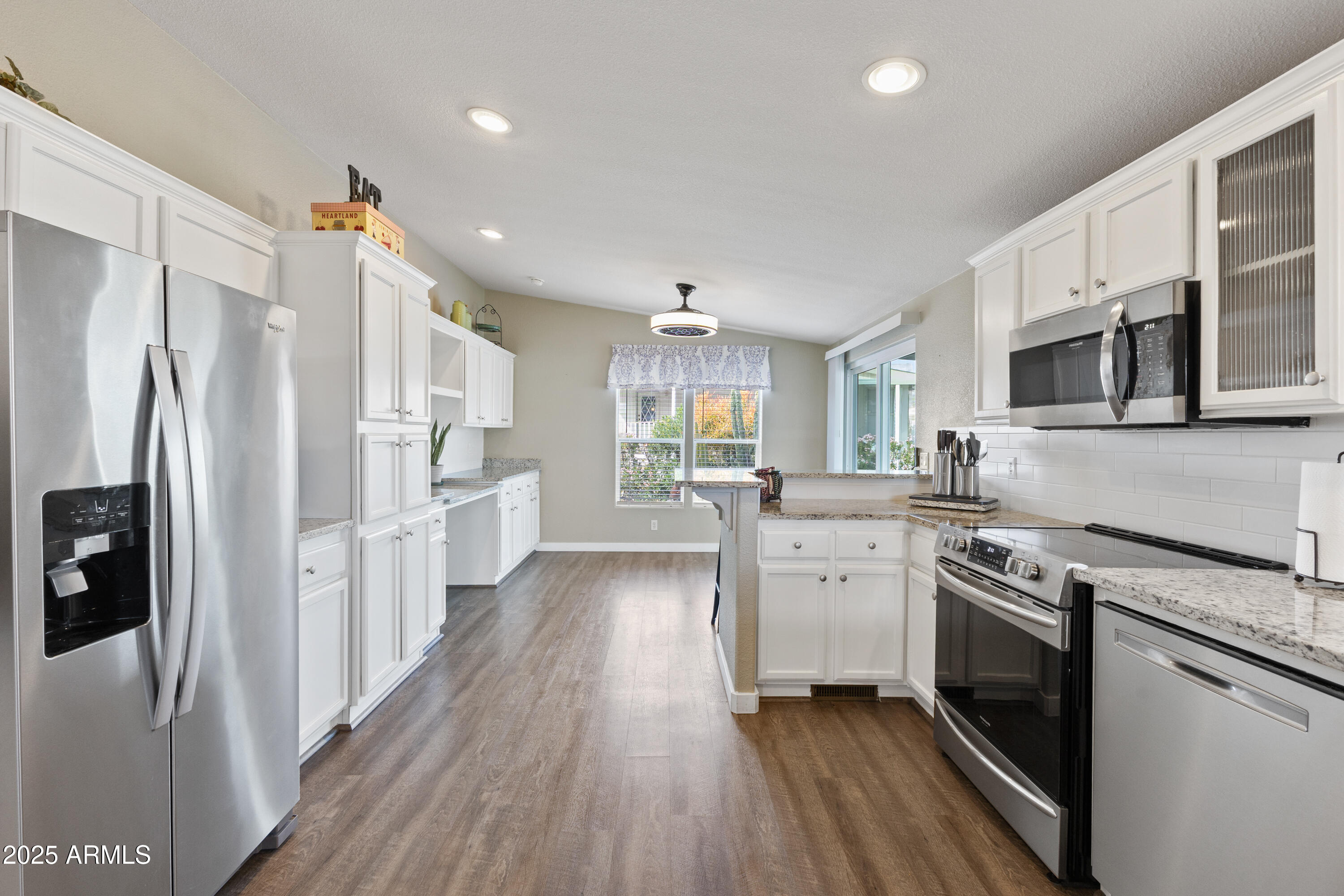 2000 South Apache Road, Unit 156 Buckeye, AZ 85326 - Photo 13 of 40 a kitchen with white cabinets and stainless steel appliances