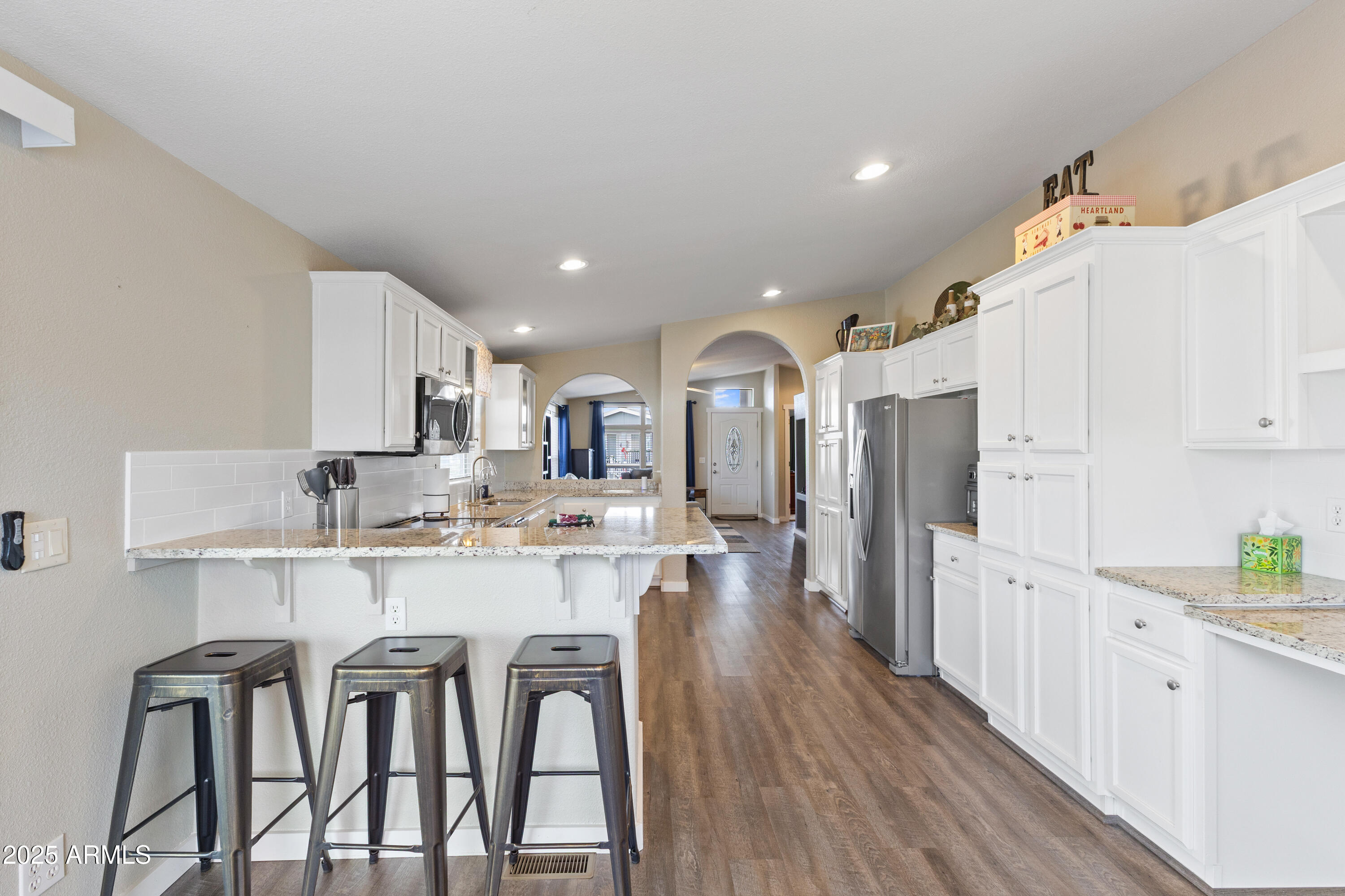 2000 South Apache Road, Unit 156 Buckeye, AZ 85326 - Photo 16 of 40 a large white kitchen with lots of counter space a refrigerator and cabinets