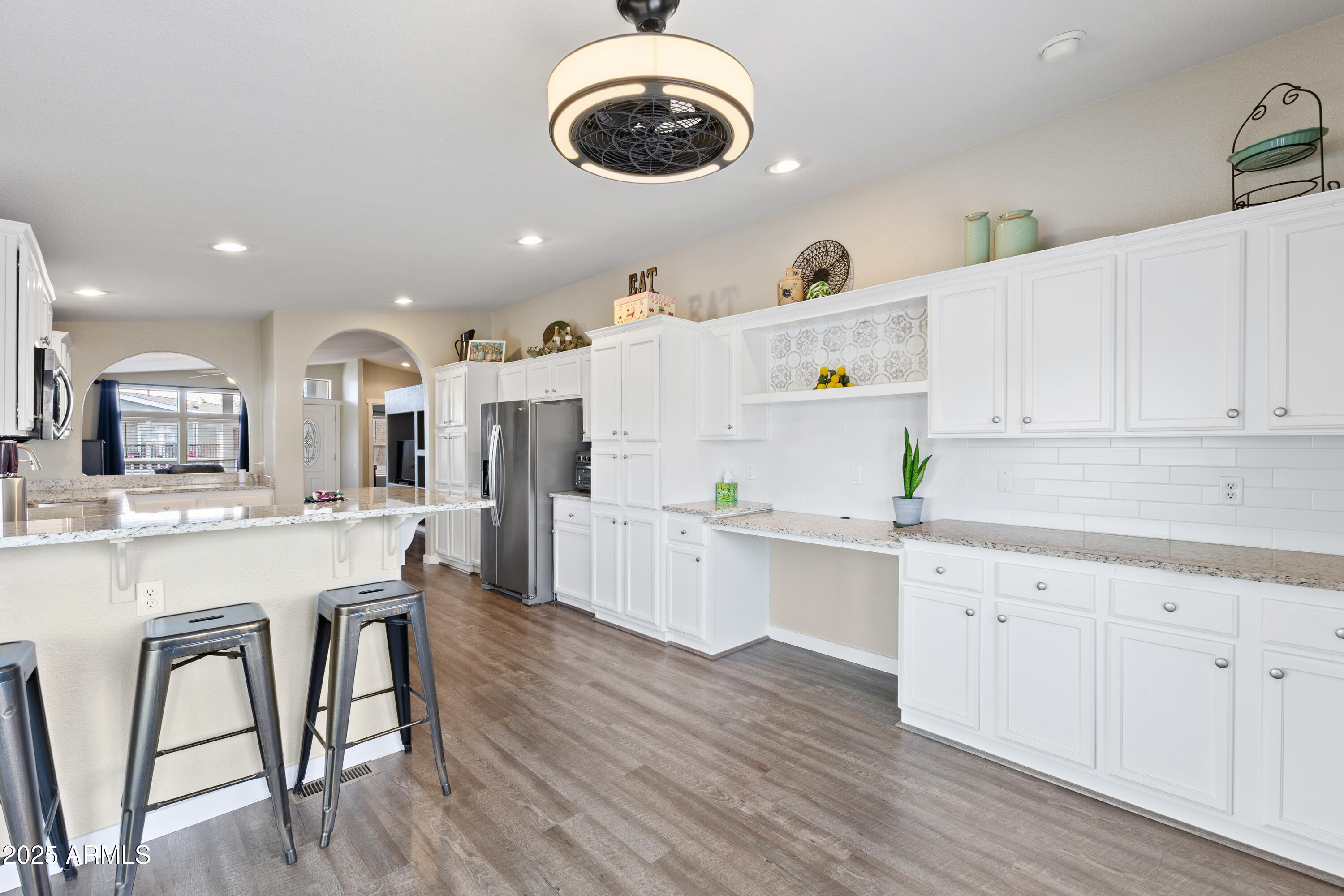 2000 South Apache Road, Unit 156 Buckeye, AZ 85326 - Photo 19 of 40 a kitchen with a wooden floor and white cabinets