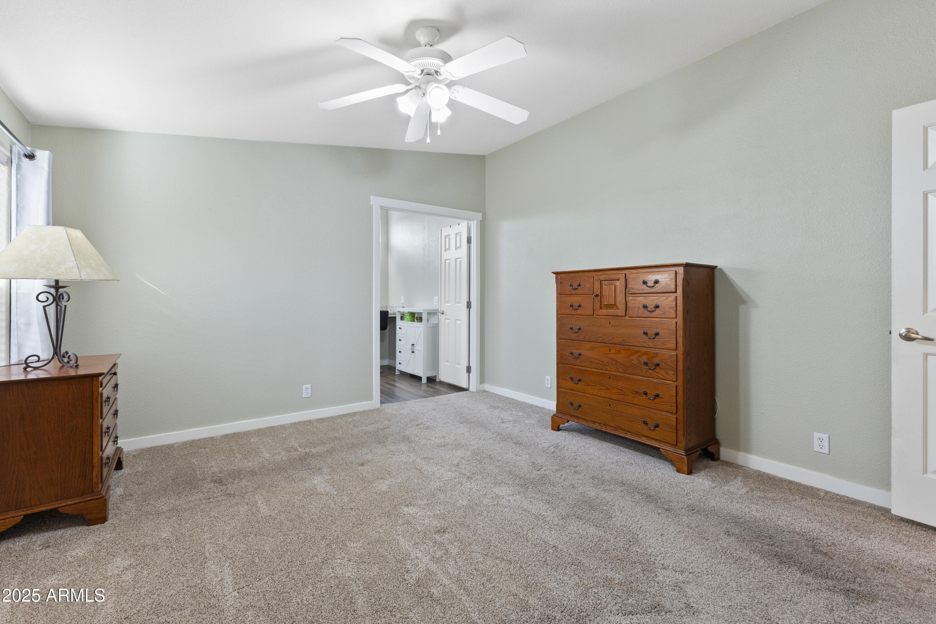 2000 South Apache Road, Unit 156 Buckeye, AZ 85326 - Photo 23 of 40 an empty room with a mirror and a ceiling fan