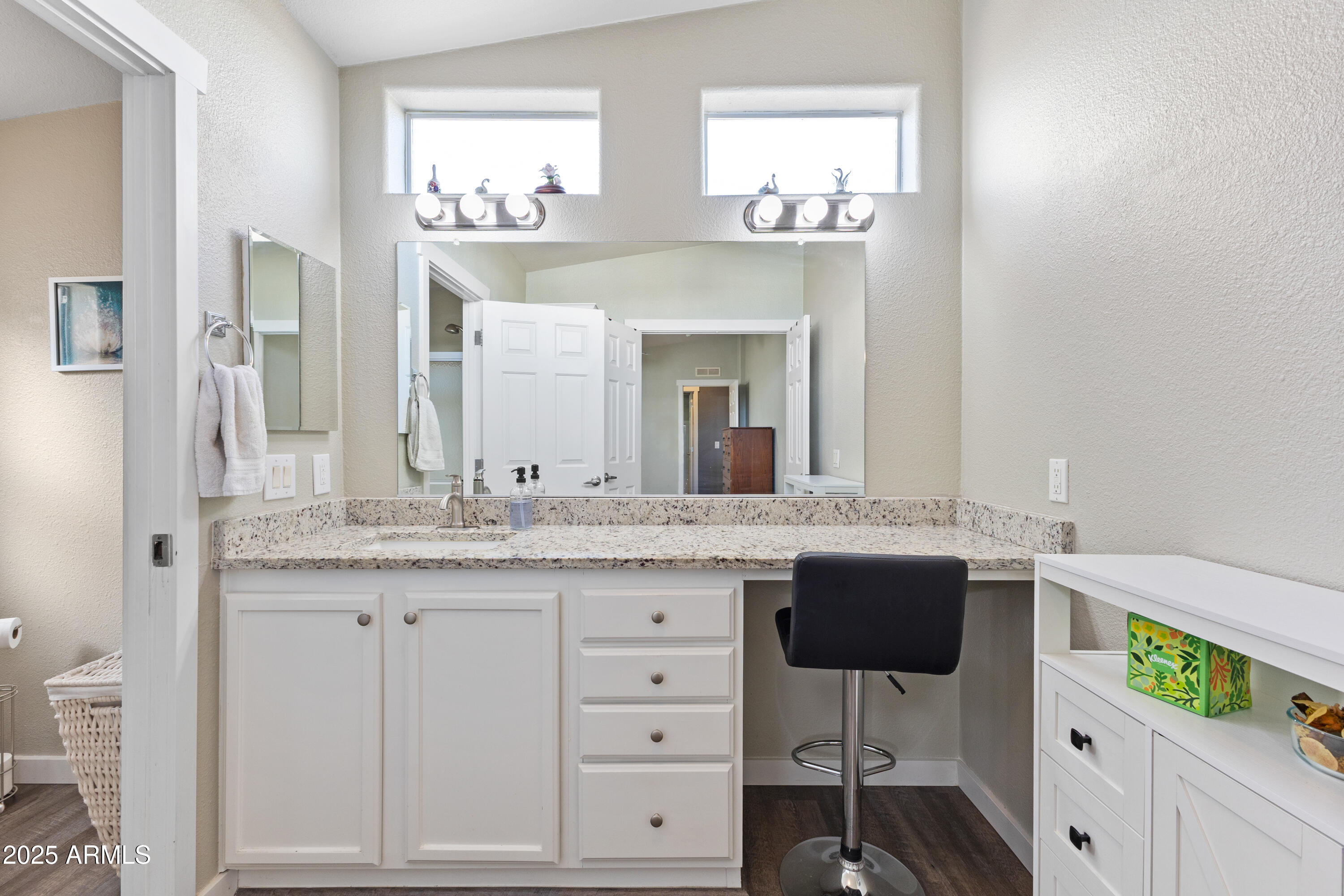 2000 South Apache Road, Unit 156 Buckeye, AZ 85326 - Photo 25 of 40 a spacious bathroom with a granite countertop sink and a large mirror