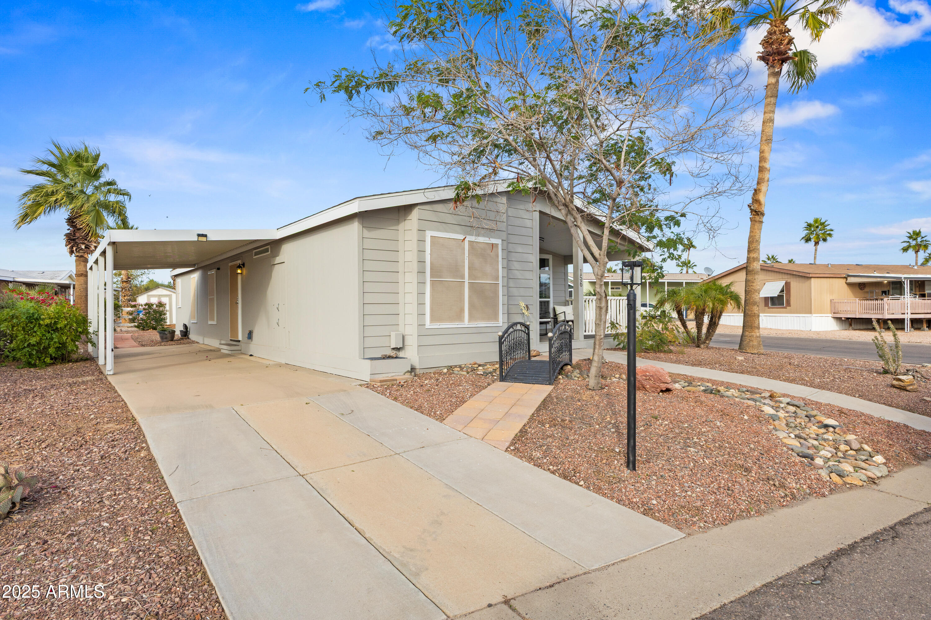 2000 South Apache Road, Unit 156 Buckeye, AZ 85326 - Photo 3 of 40 a front view of a house with garden