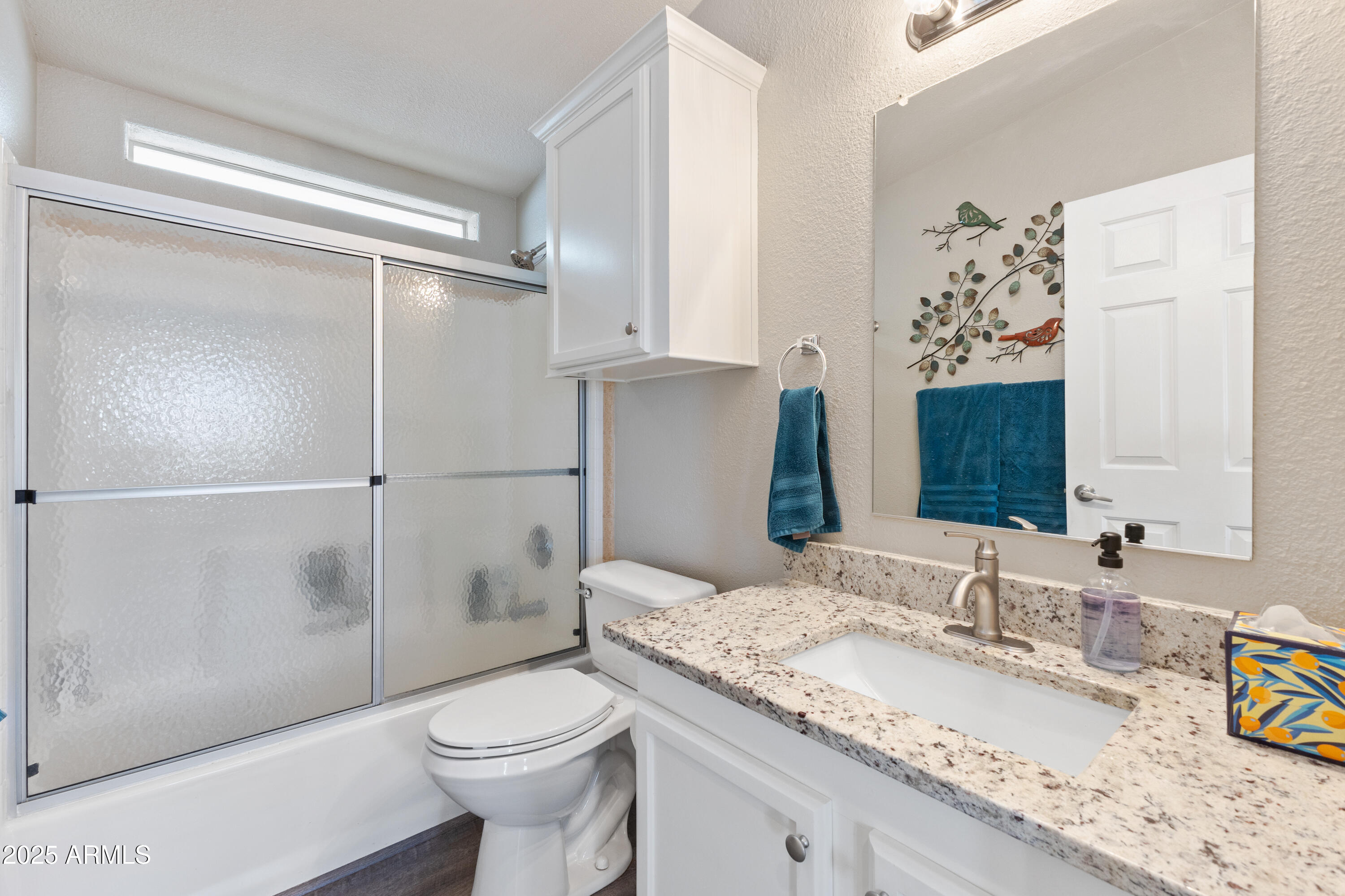 2000 South Apache Road, Unit 156 Buckeye, AZ 85326 - Photo 31 of 40 a bathroom with a granite countertop sink toilet and shower