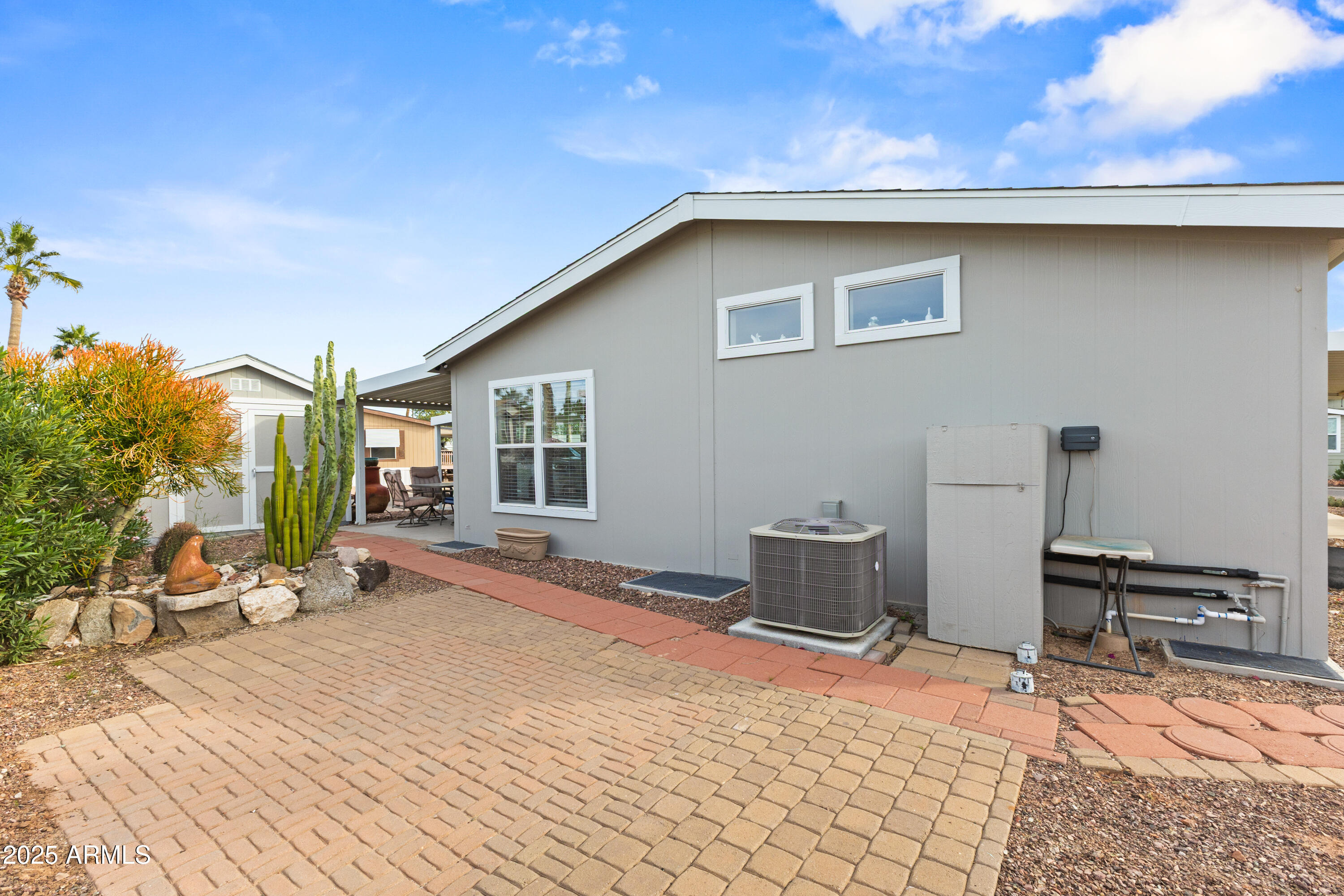2000 South Apache Road, Unit 156 Buckeye, AZ 85326 - Photo 35 of 40 a backyard of a house with table and chairs