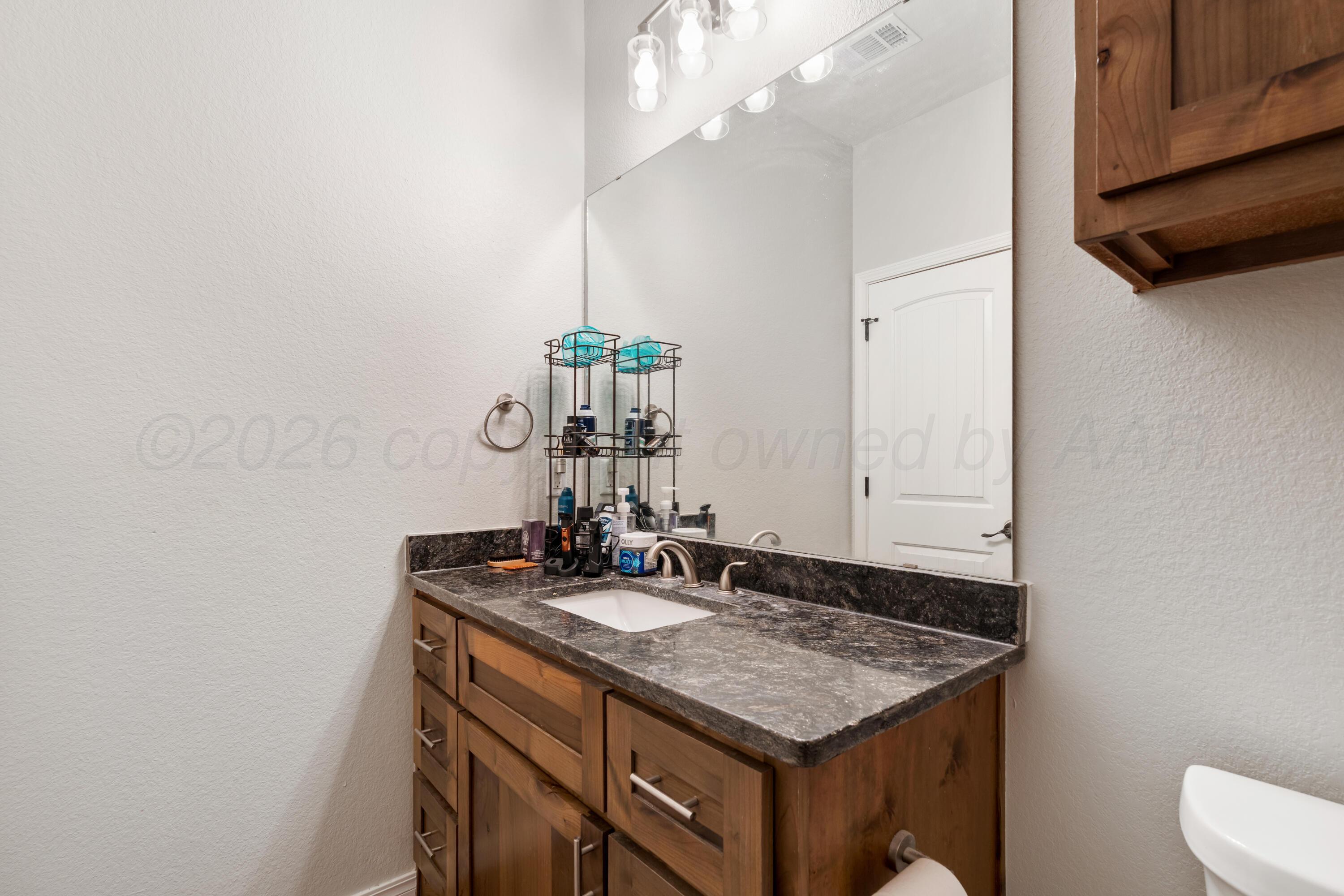 151 North Fm 2381 Amarillo, TX 79124 - Photo 22 of 36 a bathroom with a sink a vanity and a mirror
