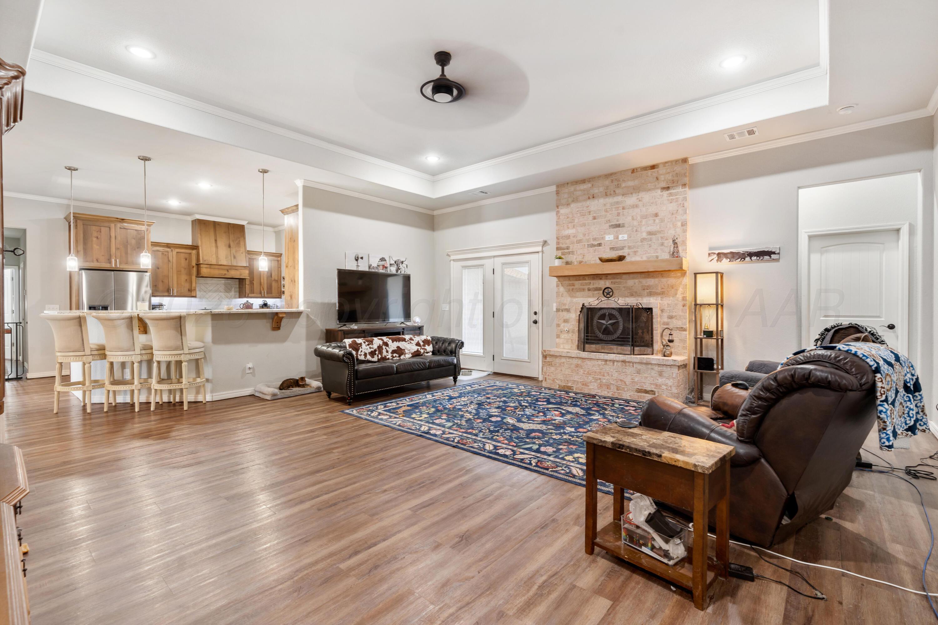 151 North Fm 2381 Amarillo, TX 79124 - Photo 8 of 36 a living room with furniture and a fireplace with wooden floor