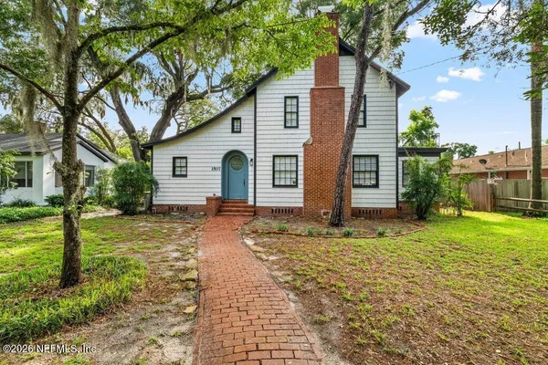 a backyard of a house with plants and outdoor seating