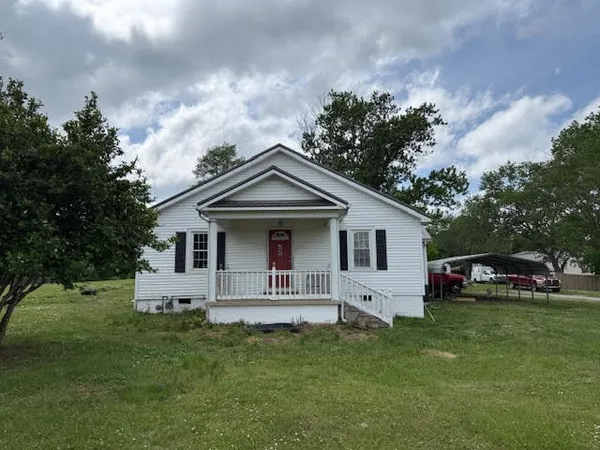 a front view of house with yard and green space