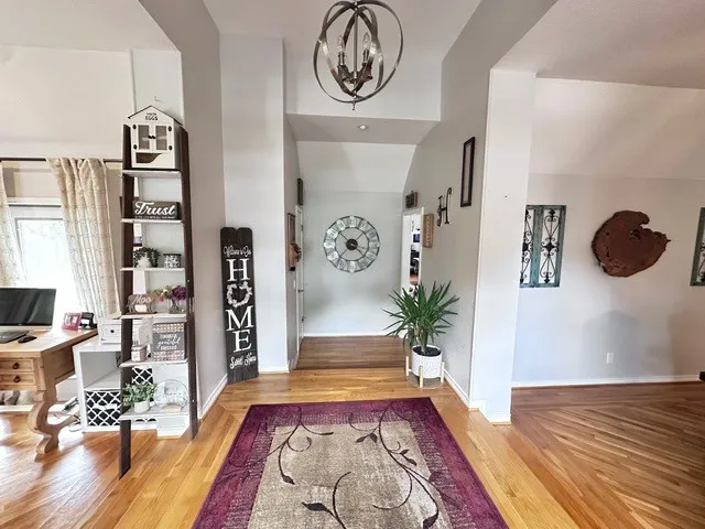 a bedroom with a bed dresser and a flat tv screen