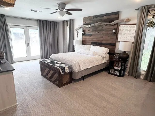 a large tub sitting in a bathroom and mirror