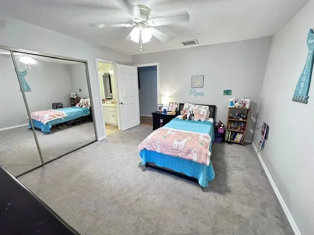 a spacious bedroom with a bed and a couch