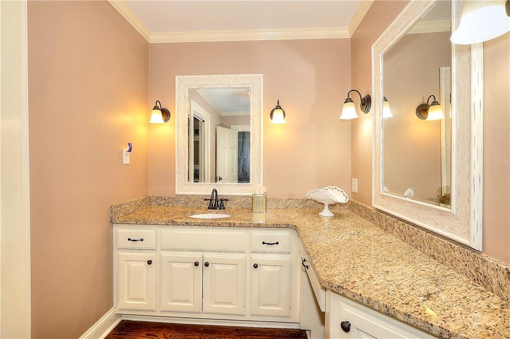 317 North Cherokee Road Social Circle, GA 30025 - Photo 18 of 32 a bathroom with a granite countertop sink and a mirror