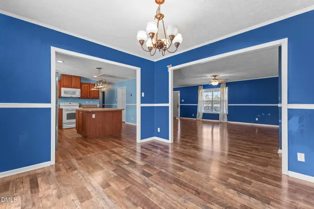 a view of a room with wooden floor and windows