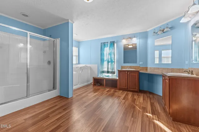 a view of a kitchen with wooden floor and a sink