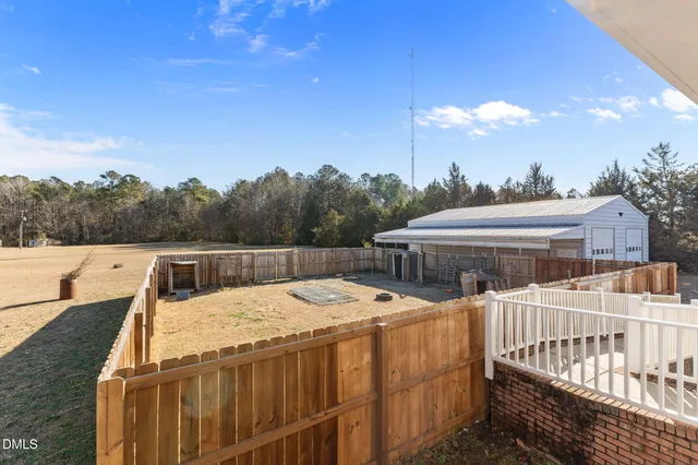 a view of a house with pool and chairs