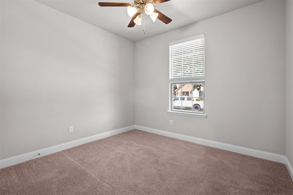 119 Happy Lane Red Oak, TX 75154 - Photo 29 of 37 Neutral-toned wall finishes featuring a single window with blinds, a ceiling fan with light fixture, and brown carpet flooring