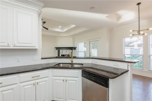a kitchen with granite countertop a sink and a stove