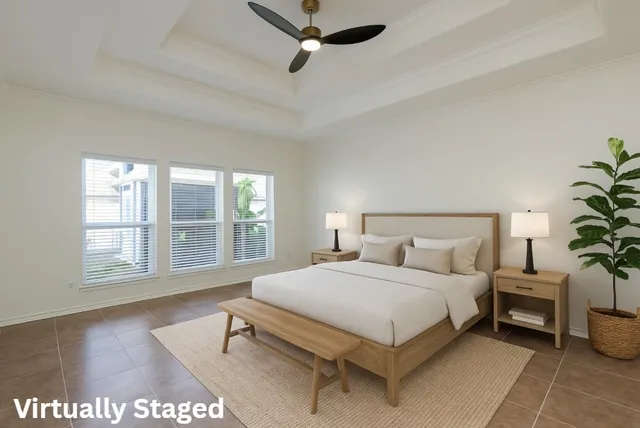 a bedroom with a bed table and a window