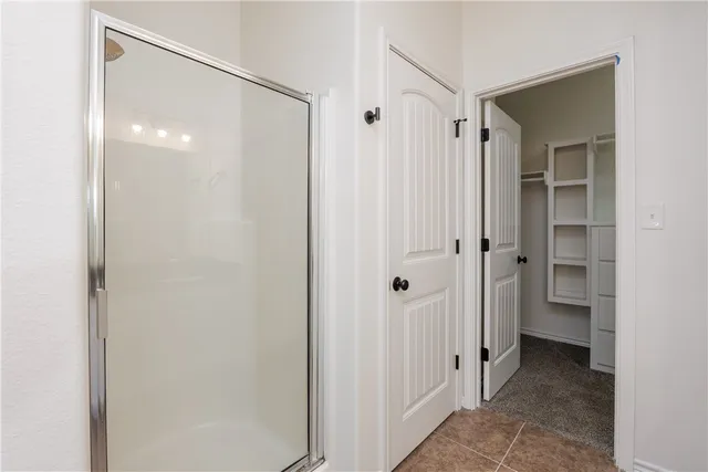 a bathroom with a shower and a sink