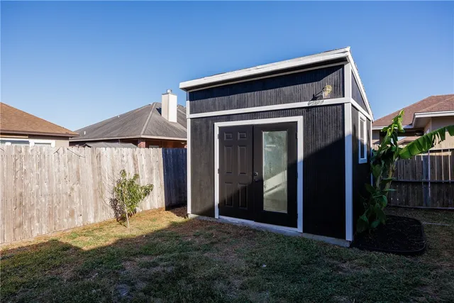 a view of house with backyard and glass windows