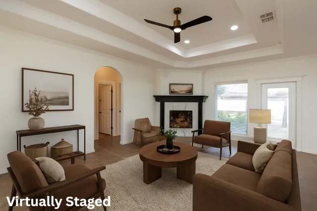 a living room with furniture a large window and a fireplace
