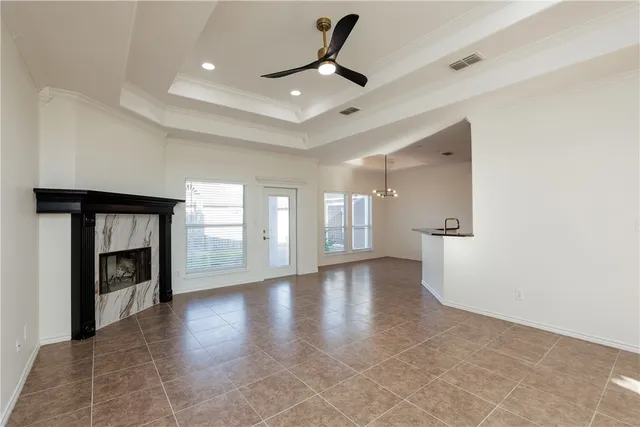a view of an empty room with a fireplace and a window