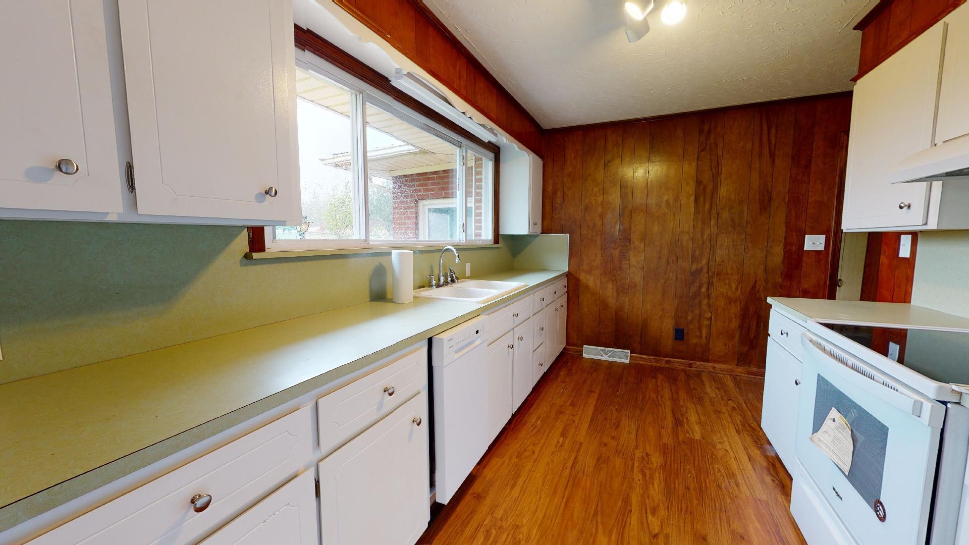 420 Long Level Road Southwest Floyd, VA 24091 - Photo 2 of 15 a kitchen with a sink and wooden cabinets