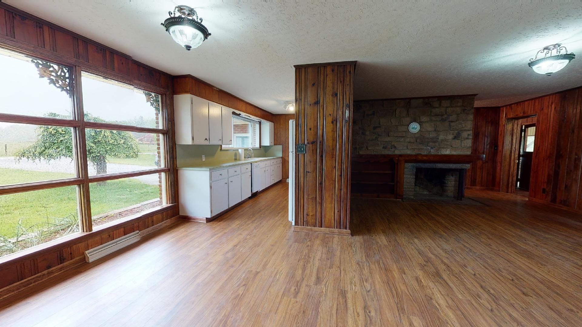 420 Long Level Road Southwest Floyd, VA 24091 - Photo 3 of 15 a view of an empty room with wooden floor fireplace and a window