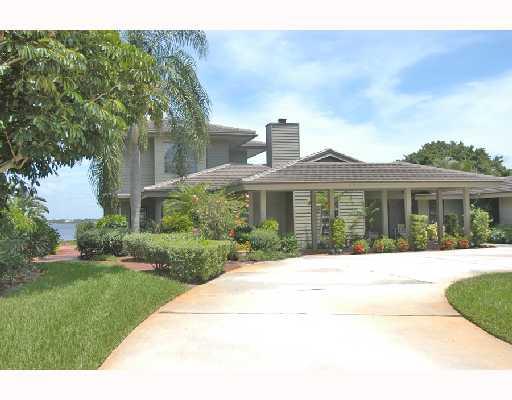 1417 Southeast Riverside Drive Stuart, FL 34996 - Photo 1 of 8 a front view of a house with a yard