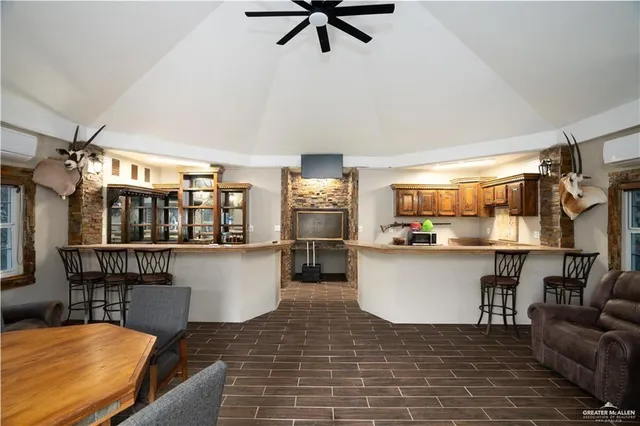 a kitchen with a table chairs refrigerator and microwave